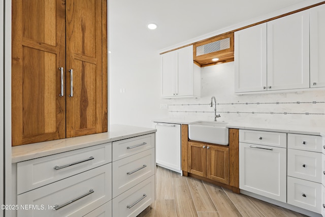 1601 Ocean Dr S Unit 410, Jacksonville Beach, FL 32250 - kitchen with a sink, dishwasher, recessed lighting, white cabinets, and light wood-style floors