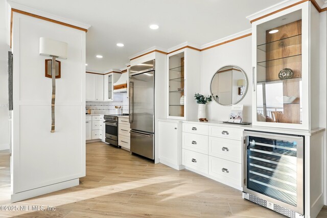 1601 Ocean Dr S Unit 410, Jacksonville Beach, FL 32250 - kitchen with appliances with stainless steel finishes, beverage cooler, open shelves, white cabinetry, and glass insert cabinets