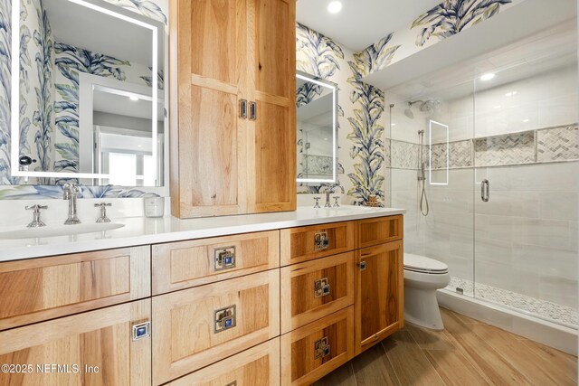 1601 Ocean Dr S Unit 410, Jacksonville Beach, FL 32250 - full bath featuring wallpapered walls, toilet, a shower stall, double vanity, and wood finished floors