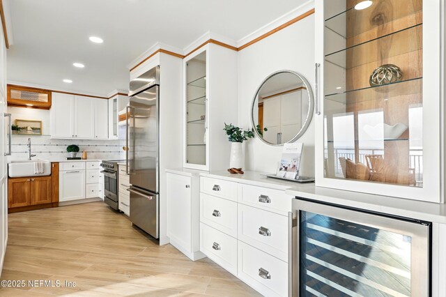 1601 Ocean Dr S Unit 410, Jacksonville Beach, FL 32250 - kitchen with beverage cooler, stainless steel appliances, a sink, open shelves, and recessed lighting