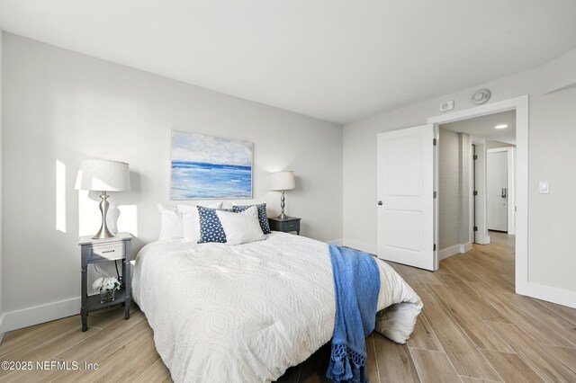 1601 Ocean Dr S Unit 410, Jacksonville Beach, FL 32250 - bedroom featuring baseboards and light wood finished floors
