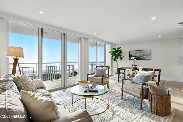 1601 Ocean Dr S Unit 410, Jacksonville Beach, FL 32250 - living area with expansive windows, a water view, wood finished floors, baseboards, and recessed lighting