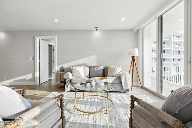 1601 Ocean Dr S Unit 410, Jacksonville Beach, FL 32250 - living area featuring plenty of natural light, wood finished floors, wallpapered walls, and baseboards