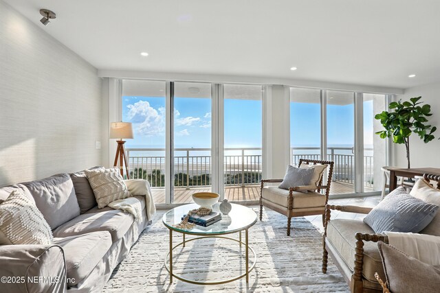 1601 Ocean Dr S Unit 410, Jacksonville Beach, FL 32250 - living area with a wall of windows, a water view, and recessed lighting