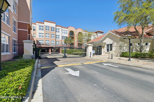 10435 Midtown Pkwy Unit 448, Jacksonville, FL 32246 - view of road with street lights, a gated entry, curbs, and a gate