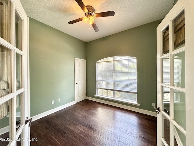 1317 Honeysuckle Dr, Saint Johns, FL 32259 - spare room featuring a textured ceiling, french doors, baseboards, and dark wood finished floors