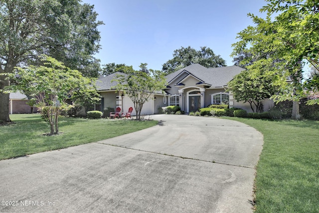 1317 Honeysuckle Dr, Saint Johns, FL 32259 - ranch-style home with concrete driveway, an attached garage, stucco siding, and a front lawn