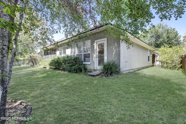 1317 Honeysuckle Dr, Saint Johns, FL 32259 - view of side of property featuring a yard, stucco siding, and fence