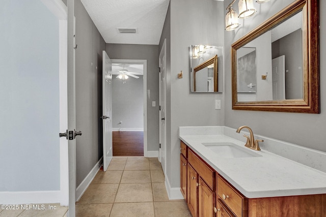 1317 Honeysuckle Dr, Saint Johns, FL 32259 - bathroom with vanity, baseboards, tile patterned floors, a ceiling fan, and visible vents