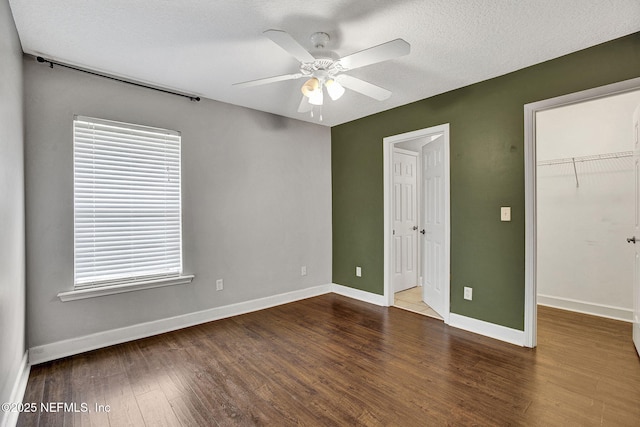 1317 Honeysuckle Dr, Saint Johns, FL 32259 - unfurnished bedroom with a spacious closet, baseboards, ceiling fan, and wood finished floors