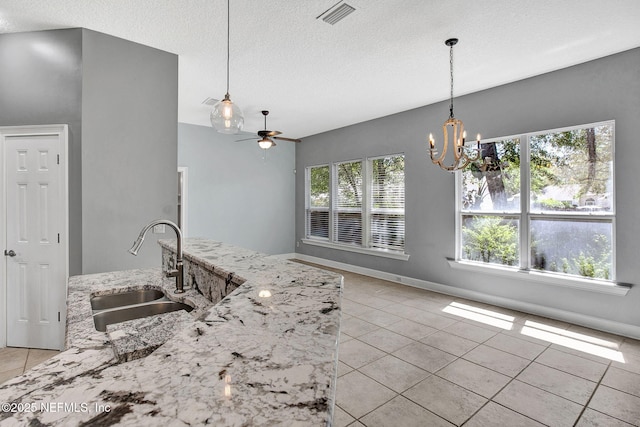 1317 Honeysuckle Dr, Saint Johns, FL 32259 - kitchen with light tile patterned floors, a textured ceiling, visible vents, ceiling fan with notable chandelier, and a sink