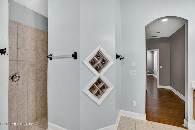 1317 Honeysuckle Dr, Saint Johns, FL 32259 - hall with baseboards, arched walkways, and tile patterned flooring