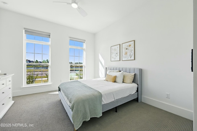 bedroom with ceiling fan, baseboards, and light carpet