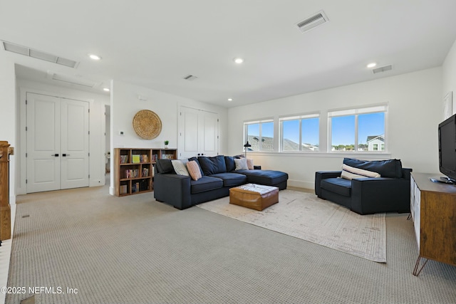 carpeted living room featuring recessed lighting and visible vents