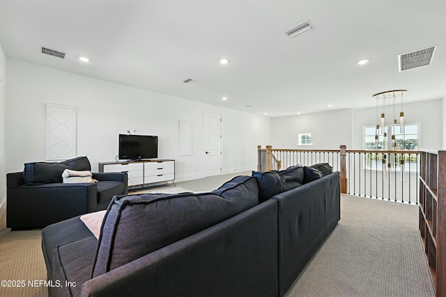 living area featuring visible vents and recessed lighting