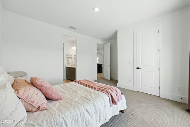 bedroom with visible vents, baseboards, light colored carpet, recessed lighting, and ensuite bath