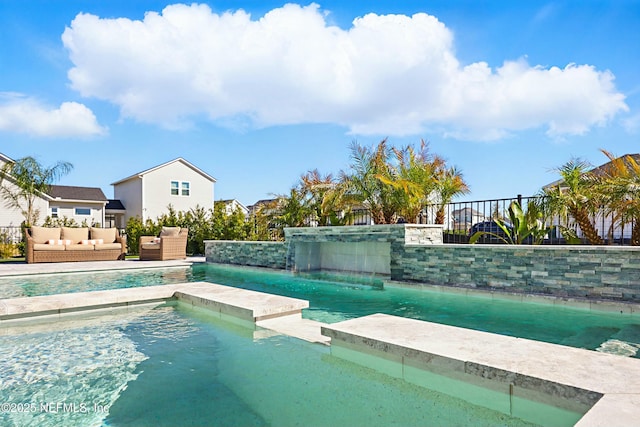 view of pool featuring an outdoor living space, a fenced in pool, and fence