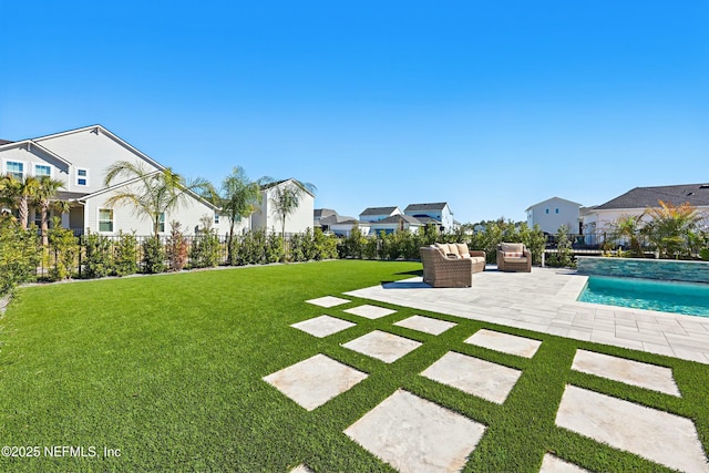 view of yard with outdoor lounge area, a patio, fence, and a residential view