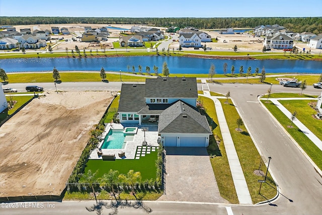 drone / aerial view with a residential view and a water view
