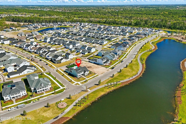 birds eye view of property featuring a residential view, a view of trees, and a water view