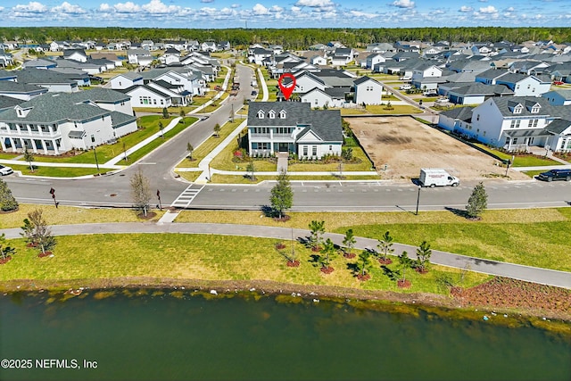 drone / aerial view featuring a residential view and a water view