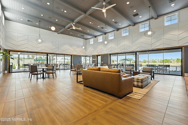 living room featuring visible vents, beam ceiling, a healthy amount of sunlight, and ceiling fan