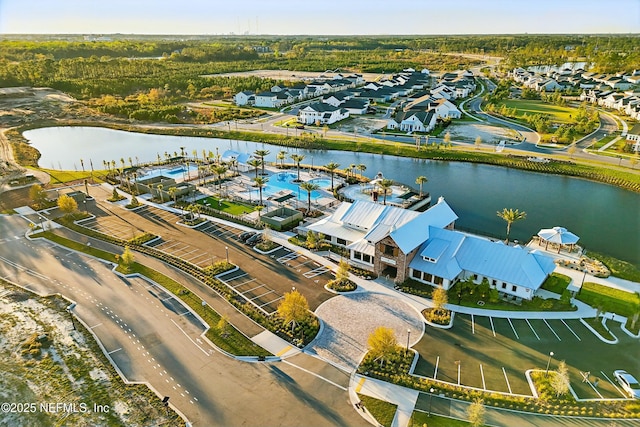 drone / aerial view featuring a residential view and a water view
