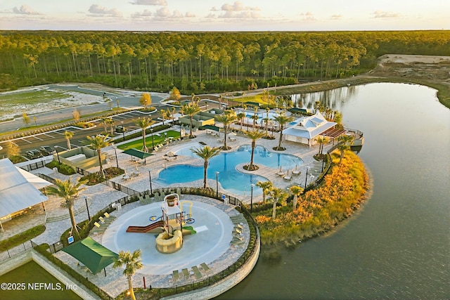 birds eye view of property with a water view and a view of trees