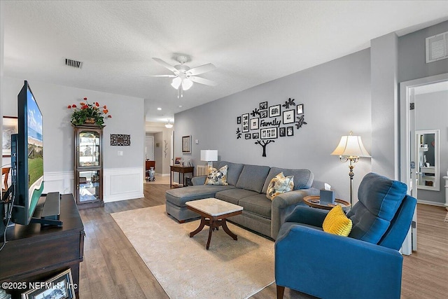 6738 White Blossom Cir Unit 36G, Jacksonville, FL 32258 - living room featuring wood finished floors, a textured ceiling, ceiling fan, and visible vents