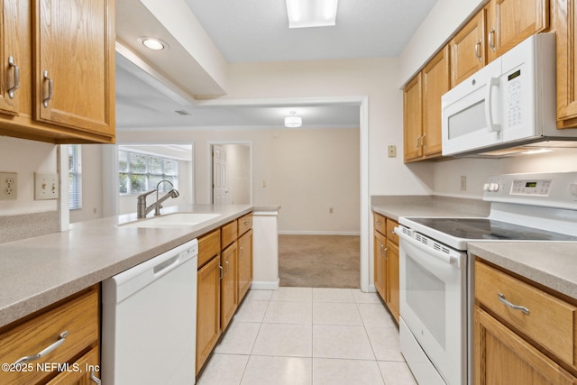 4532 Middleton Park Cir W, Jacksonville, FL 32224 - kitchen with a sink, white appliances, brown cabinetry, light countertops, and light tile patterned floors