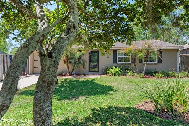 2795 Kiowa Ave, Orange Park, FL 32065 - view of front of home featuring concrete driveway, stucco siding, fence, an attached garage, and a front yard