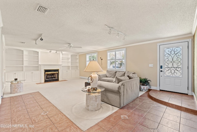 2795 Kiowa Ave, Orange Park, FL 32065 - tiled living room featuring a textured ceiling, visible vents, a ceiling fan, and ornamental molding