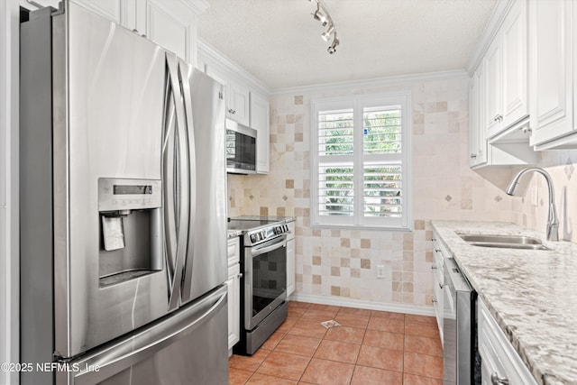 2795 Kiowa Ave, Orange Park, FL 32065 - kitchen with light tile patterned flooring, a sink, white cabinetry, a textured ceiling, and stainless steel appliances
