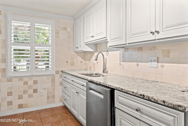 2795 Kiowa Ave, Orange Park, FL 32065 - kitchen with white cabinets, dishwasher, ornamental molding, a sink, and light tile patterned floors