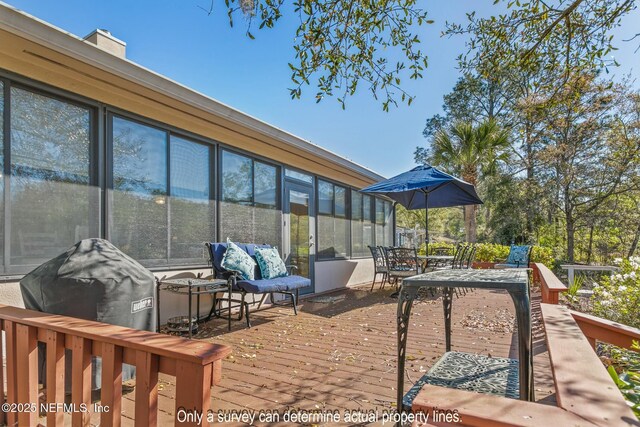 85 Fox Valley Dr, Orange Park, FL 32073 - view of patio with a sunroom, outdoor dining area, and a deck