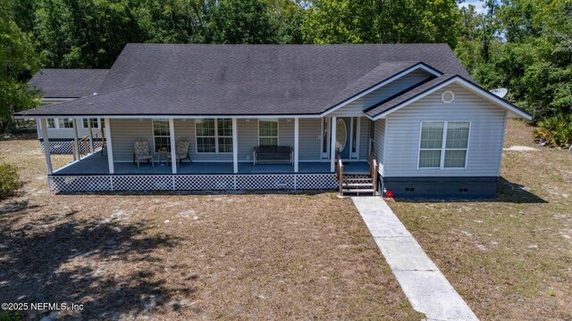 5398 Laurie Ln, Middleburg, FL 32068 - view of front of property with crawl space, a shingled roof, a front lawn, and covered porch