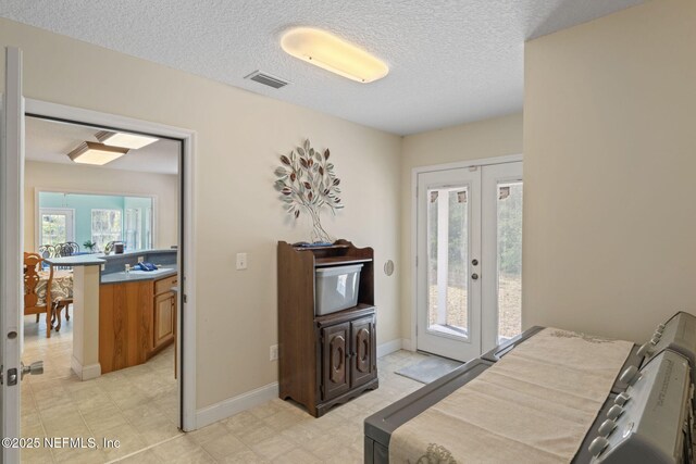 5398 Laurie Ln, Middleburg, FL 32068 - bedroom featuring access to outside, multiple windows, a textured ceiling, french doors, and baseboards