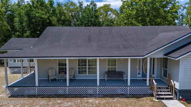 5398 Laurie Ln, Middleburg, FL 32068 - rear view of house featuring a shingled roof and a porch