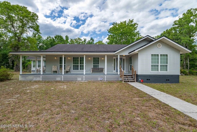 5398 Laurie Ln, Middleburg, FL 32068 - view of front facade with a porch, crawl space, and a front lawn