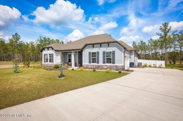 view of front of house with stone siding, concrete driveway, a garage, and a front yard