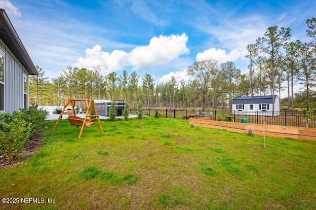 view of yard with an outbuilding and fence