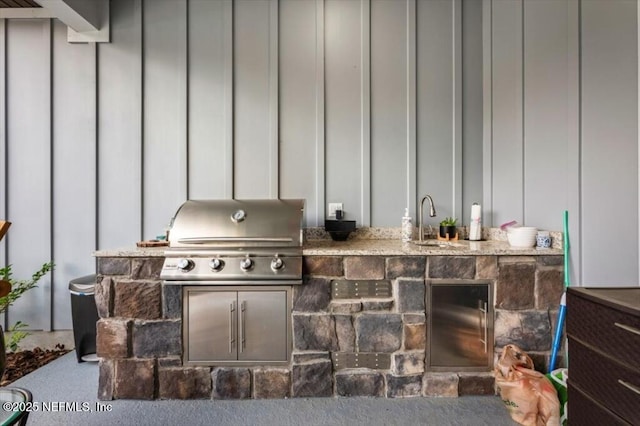 view of patio with a sink, exterior kitchen, and a grill