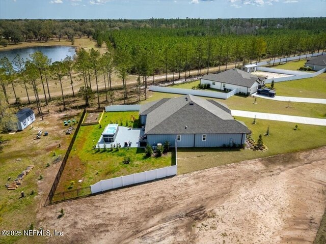 aerial view with a wooded view and a water view