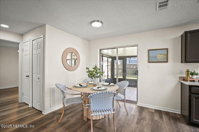 14319 Cedar Island Rd N, Jacksonville, FL 32250 - dining space with dark wood-style floors, baseboards, and visible vents
