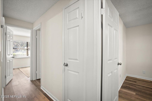 14319 Cedar Island Rd N, Jacksonville, FL 32250 - hall featuring a textured ceiling, baseboards, and wood finished floors