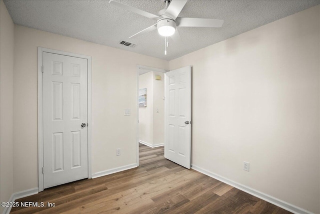 14319 Cedar Island Rd N, Jacksonville, FL 32250 - unfurnished bedroom with baseboards, visible vents, wood finished floors, and a textured ceiling