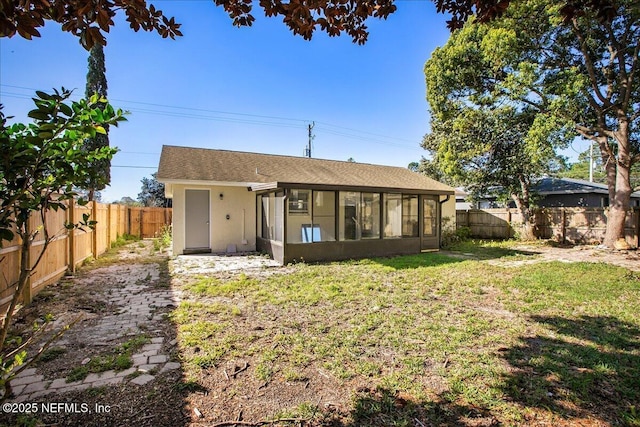 14319 Cedar Island Rd N, Jacksonville, FL 32250 - back of property featuring a fenced backyard, stucco siding, a sunroom, and a yard