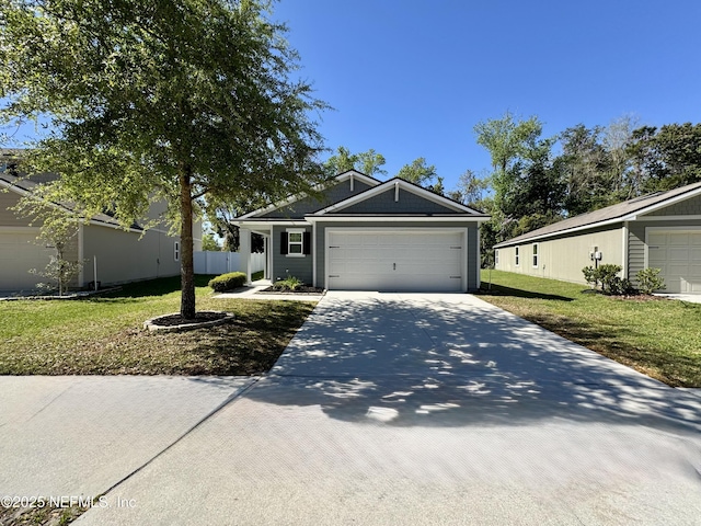 view of front of home with a front yard, an attached garage, fence, and driveway
