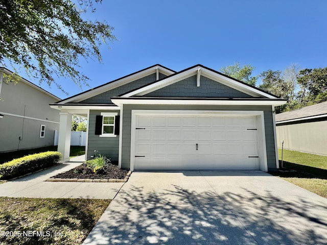 view of front of property featuring a garage and driveway