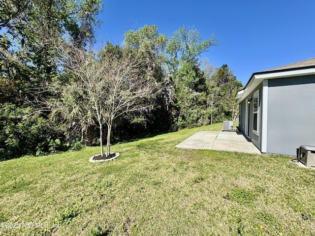 view of yard with a patio and central AC unit